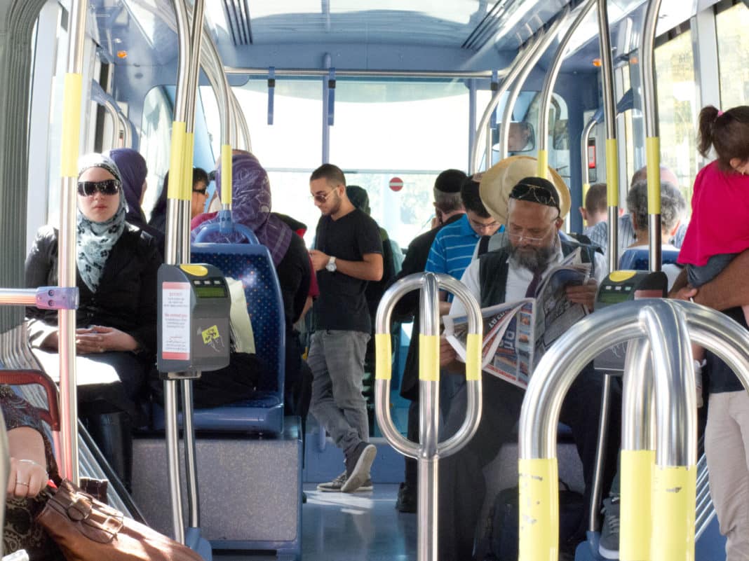 Israelis of all backgrounds traveling side-by-side on Jerusalem's light rail.