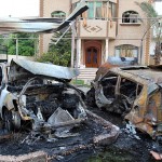 A Palestinian man looks at burnt cars outside a house after an Israeli air strike in Gaza A Palestinian man looks at burnt cars outside a house after an Israeli air strike in Gaza Strip June 20, 2012. The Israeli military said it had struck militant sites on Wednesday in retaliation to rocket fire into Israel earlier.