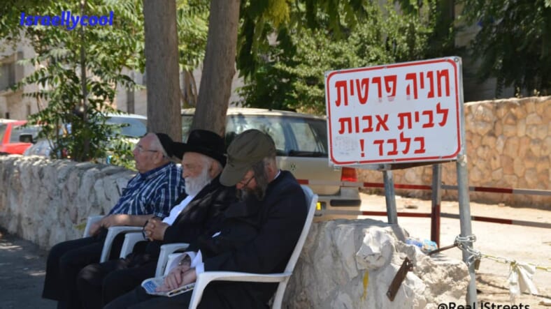 image men sleeping on public bench