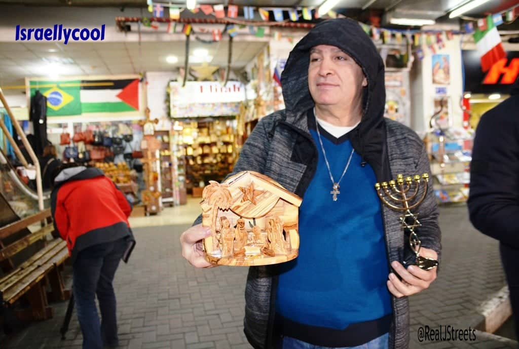 In Bethlehem bus station man asks tourists to buy menorah or creche before Christmas holiday