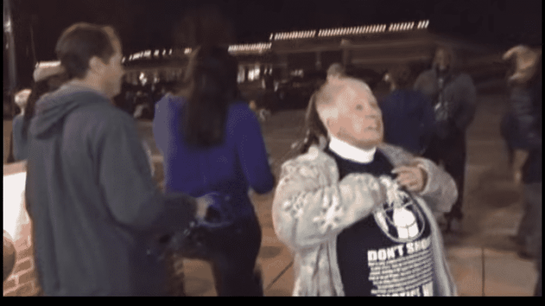 screen shot of woman protesting against CNN