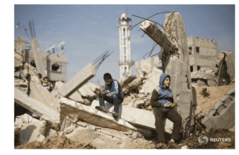 Muslim boys praying in ruins