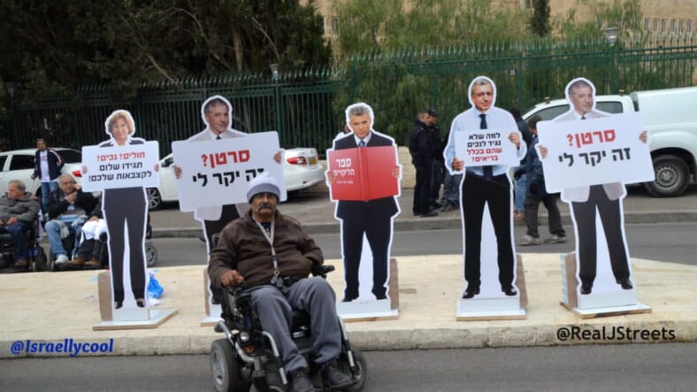 image disabled man, picture Jerusalem protest, image unusual protest signs