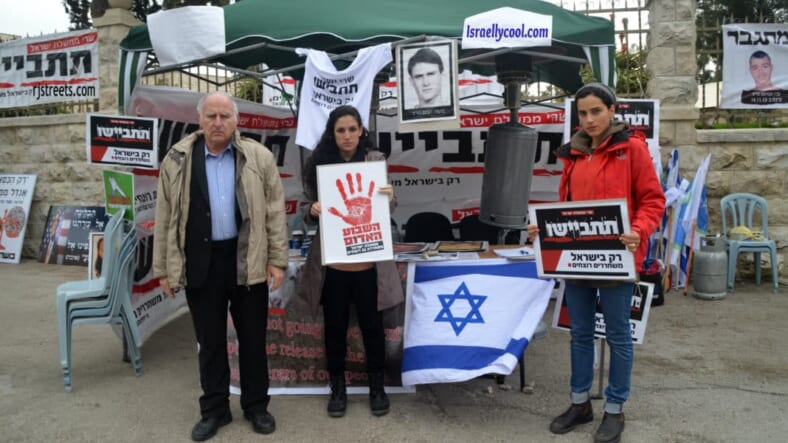 image protest against prisoner release, image family members protest, photo tent near prime ministers home, picture prisoner release protest