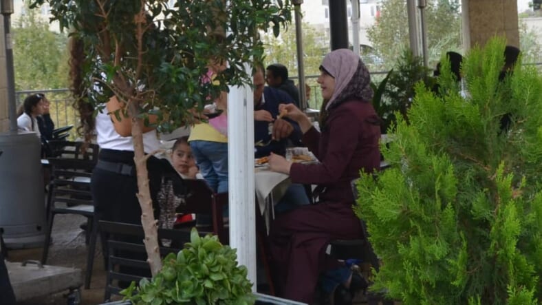 image Israel apartheid, photo BDS, picture Israel occuaption, Muslim family eating