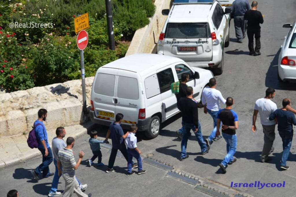 Muslims walk home after Friday prayers at Al Aqsa and walk by security