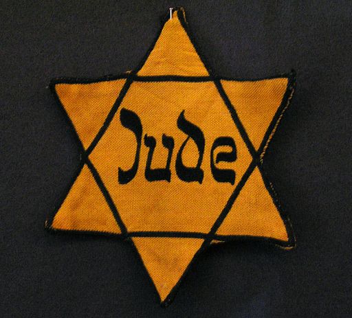 Yellow badge Star of David called "Judenstern". Part of the exhibition in the Jewish Museum Westphalia, Dorsten, Germany. The wording is the German word for Jew (Jude), written in mock-Hebrew script.(Photo: CC-BY-SA Daniel Ullrich, Threedots, Wikipedia)