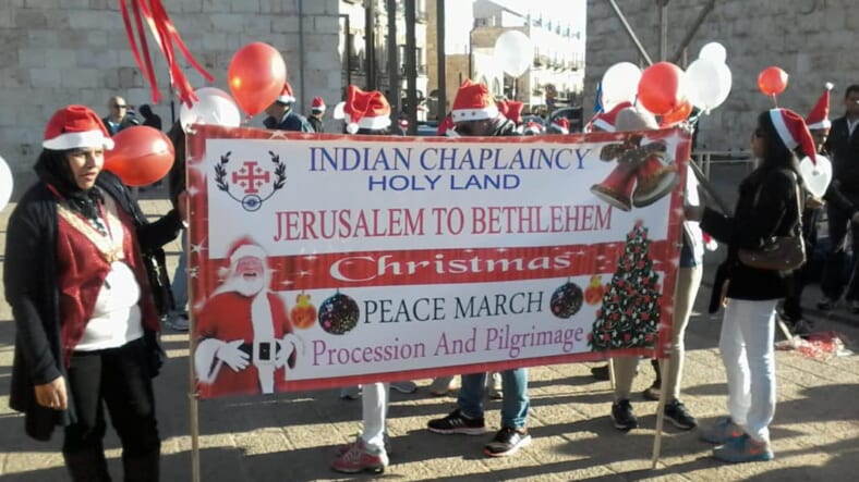 image Indian workers in Santa hats at Jaffa Gate
