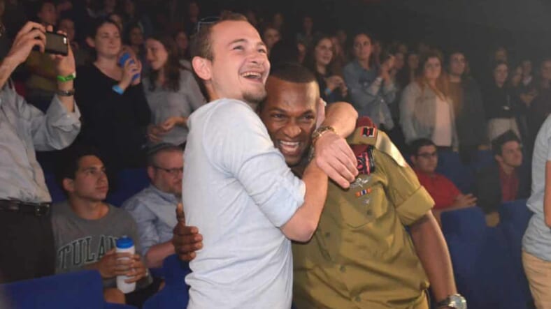 Mekonen gets hug from his former commander at film premiere in Jerusalem