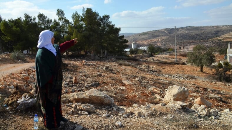 82 year old Arab woman points to her land in Amona for reports on Media Central trip of Ofra