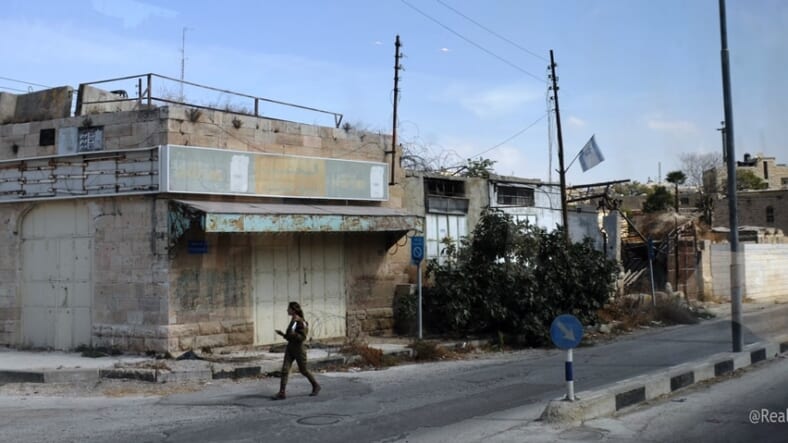 Deserted street in Hebron one IDF soldier walking 
