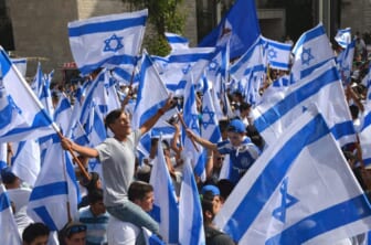 Israeli flags boys dancing on King George Street on Yom Yerushalayim before Jerusalem Day FlagParade