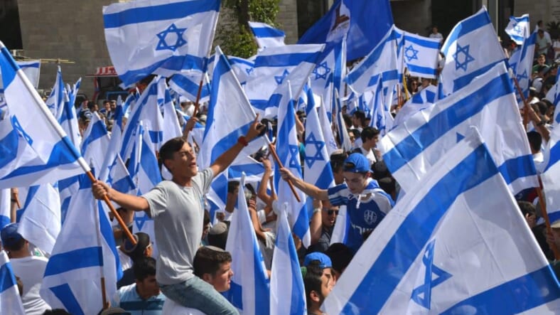Israeli flags boys dancing on King George Street on Yom Yerushalayim before Jerusalem Day FlagParade
