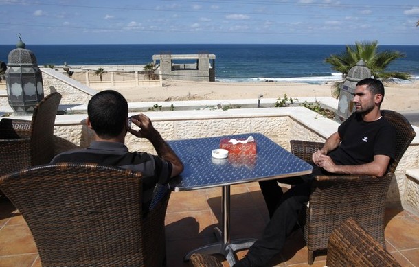 Two freed Palestinian prisoners sit at the cafe of Al-Mashtal hotel, where they are staying, in the Gaza Strip October 19, 2011. Israeli soldier Gilad Shalit and hundreds of Palestinians crossed Israel's borders in opposite directions on Tuesday as a thousand-for-one prisoner exchange brought joy to families but did little to ease decades of conflict. REUTERS/Ahmed Jadallah