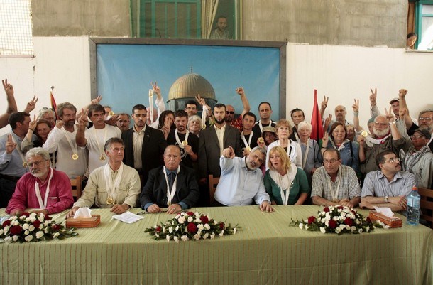 International activists meet with senior Hamas leader Ismail Haniyeh at his house after they arrived in Gaza August 24, 2008. Two boats carrying activists challenging an Israeli blockade on the Gaza Strip reached the shore of the Hamas-controlled territory on Saturday. The 44 "Free Gaza" activists from 17 nations, who had set out on Friday from Cyprus in two wooden boats, were met by thousands of Palestinians who cheered along the shoreline at their arrival. REUTERS/Mohammed Salem (GAZA)