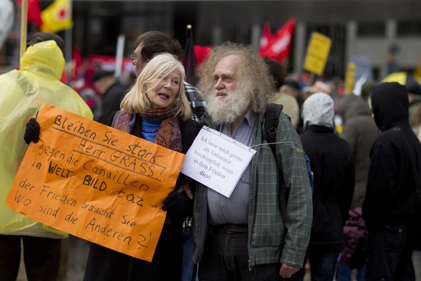 People hold placards in support of German author Guenter Grass during the traditional Ostermarsch in Berlin