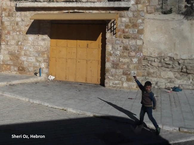 child throwing stones in Hebron