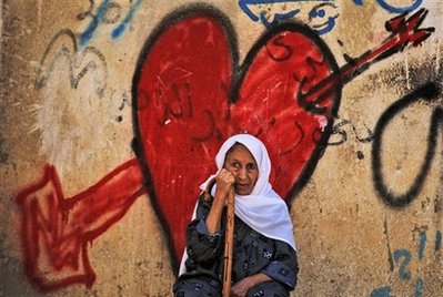 Palestinian woman heart mural AP