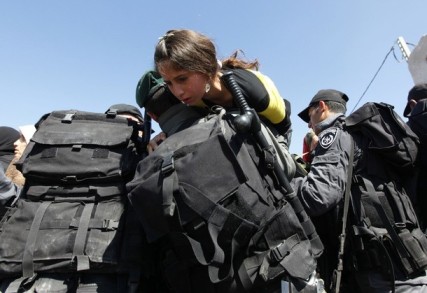 soldiers helping girl - Reuters